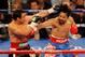LAS VEGAS, NV - NOVEMBER 12: (L-R) Juan Manuel Marquez and Manny Pacquiao exchange blows during the WBO world welterweight title fight at the MGM Grand Garden Arena on November 12, 2011 in Las Vegas, Nevada. (Photo by Ethan Miller/Getty Images)