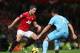 MANCHESTER, ENGLAND - NOVEMBER 28: Robin van Persie of Manchester United takes on Winston Reid of West Ham United during the Barclays Premier League match between Manchester United and West Ham United at Old Trafford on November 28, 2012 in Manchester, England. (Photo by Clive Brunskill/Getty Images)
