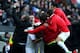 MILTON KEYNES, ENGLAND - DECEMBER 02: Jon Otsemobor of MK Dons is mobbed by team mates as scores their second goal during the FA Cup with Budweiser Second Round match between MK Dons and AFC Wimbledon at StadiumMK on December 2, 2012 in Milton Keynes, England. This match is the first meeting between the two teams following the formation of AFC Wimbledon (the football club formed in 2002 by supporters unhappy with their club's relocation to Milton Keynes) and the MK Dons (which Wimbledon F.C. controversially became). (Photo by Jan Kruger/Getty Images)