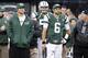 Tebow and Sanchez watch from the same vantage point for different reasons.