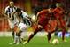 LIVERPOOL, ENGLAND - OCTOBER 04: Luis Suarez of Liverpool competes with Maurizio Domizzi of Udinese Calcio during the UEFA Europa League Group A match between Liverpool and Udinese at Anfield on October 4, 2012 in Liverpool, England. (Photo by Clive Brunskill/Getty Images)