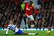 MANCHESTER, ENGLAND - NOVEMBER 24: Danny Welbeck of Manchester United hurdles the tackle of Adel Taarabt of Queens Park Rangers during the Barclays Premier League match between Manchester United and Queens Park Rangers at Old Trafford on November 24, 2012 in Manchester, England. (Photo by Laurence Griffiths/Getty Images)