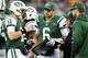 EAST RUTHERFORD, NJ - DECEMBER 02: Greg McElroy #14 of the New York Jets talks with quarterback coach Matt Cavanaugh while teammate Mark Sanchez#6 and Tim Tebow #15 stand by in the fourth quarter against the Arizona Cardinals on December 2, 2012 at MetLife Stadium in East Rutherford, New Jersey. The New York Jets defeated the Arizona Cardinals 7-6. (Photo by Elsa/Getty Images)