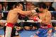 LAS VEGAS, NV - NOVEMBER 12: (L-R) Juan Manuel Marquez connects with a right to the face of Manny Pacquiao during the WBO world welterweight title fight at the MGM Grand Garden Arena on November 12, 2011 in Las Vegas, Nevada. (Photo by Ethan Miller/Getty Images)