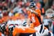 DENVER, CO - DECEMBER 2: Quarterback Peyton Manning #18 of the Denver Broncos adjusts the play at the line of scrimmage during a game against the Tampa Bay Buccaneers at Sports Authority Field Field at Mile High on December 2, 2012 in Denver, Colorado. (Photo by Dustin Bradford/Getty Images)