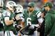 EAST RUTHERFORD, NJ - DECEMBER 02: Greg McElroy #14 of the New York Jets talks with quarterback coach Matt Cavanaugh while teammate Mark Sanchez#6 and Tim Tebow #15 stand by in the fourth quarter against the Arizona Cardinals on December 2, 2012 at MetLife Stadium in East Rutherford, New Jersey. The New York Jets defeated the Arizona Cardinals 7-6. (Photo by Elsa/Getty Images)