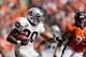 DENVER, CO - SEPTEMBER 30: Running back Darren McFadden #20 of the Oakland Raiders runs with the football as defensive tackle Derek Wolfe #95 of the Denver Broncos looks to make the tackle during the second quarter at Sports Authority Field Field at Mile High on September 30, 2012 in Denver, Colorado. (Photo by Justin Edmonds/Getty Images)