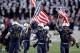 LANDOVER, MD - DECEMBER 10: John Dowd #68, Brian Blick #5, and Max Blue #44 of the Navy Midshipmen carry the American flags onto the field before the start of the 112th annual Army-Navy Game of the Navy Midshipmen at FedEx Field on December 10, 2011 in Landover, Maryland. (Photo by Rob Carr/Getty Images)