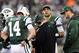 EAST RUTHERFORD, NJ - DECEMBER 02: Greg McElroy #14 of the New York Jets talks with quarterback coach Matt Cavanaugh while teammate Mark Sanchez#6 and Tim Tebow #15 stand by in the fourth quarter against the Arizona Cardinals on December 2, 2012 at MetLife Stadium in East Rutherford, New Jersey. The New York Jets defeated the Arizona Cardinals 7-6. (Photo by Elsa/Getty Images)