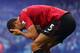 MANCHESTER, ENGLAND - DECEMBER 09: Rio Ferdinand of Manchester United reacts after being struck by an object thrown from the crowd during the Barclays Premier League match between Manchester City and Manchester United at the Etihad Stadium on December 9, 2012 in Manchester, England. (Photo by Clive Mason/Getty Images)