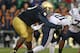 SOUTH BEND, IN - OCTOBER 20: Jamaal Williams #21 of the BYU Cougars is grabbed by Louis Nix III #9 of the Notre Dame Fighting Irish at Notre Dame Stadium on October 20, 2012 in South Bend, Indiana. Notre Dame defeated BYU 17-14. (Photo by Jonathan Daniel/Getty Images)