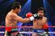 LAS VEGAS, NV - DECEMBER 08: (R-L) Manny Pacquiao throws a right at Juan Manuel Marquez during their welterweight bout at the MGM Grand Garden Arena on December 8, 2012 in Las Vegas, Nevada. (Photo by Al Bello/Getty Images)
