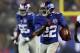 EAST RUTHERFORD, NJ - DECEMBER 09: David Wilson #22 of the New York Giants carries the ball past Isa Abdul-Quddus #42 of the New Orleans Saints to score his third touchdown of the game on December 9, 2012 at MetLife Stadium in East Rutherford, New Jersey. (Photo by Elsa/Getty Images)