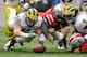 COLUMBUS, OH - NOVEMBER 24: Desmond Morgan #48 of the Michigan Wolverines and Corey Brown #3 of the Ohio State Buckeyes dive for a fumble at Ohio Stadium on November 24, 2012 in Columbus, Ohio. (Photo by Jamie Sabau/Getty Images)