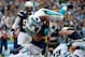 Mike Tolbert leaps over the pile for a touchdown on Sunday.