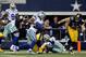 Brandon Carr's interception in overtime helped push the Cowboys into a three-way tie for first place in the NFC East with two games to go.