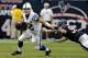 HOUSTON, TX - DECEMBER 16: Andrew Luck #12 of the Indianapolis Colts avoids the tackle by J.J. Watt #99 of the Houston Texans in the second half at Reliant Stadium on December 16, 2012 in Houston, Texas. Texans win 29-17 to clinch the AFC South. (Photo by Bob Levey/Getty Images)