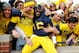 ANN ARBOR, MI - NOVEMBER 17: Denard Robinson #16 of the Michigan Wolverines celebrates a 42-17 victory over the Iowa Hawkeyes with fans at Michigan Stadium on November 17, 2012 in Ann Arbor, Michigan. (Photo by Gregory Shamus/Getty Images)