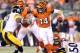 CINCINNATI, OH - OCTOBER 21: Andy Dalton #14 of the Cincinnati Bengals runs with the ball while pursued by James Harrison #92 of the Pittsburgh Steelers during the game at Paul Brown Stadium on October 21, 2012 in Cincinnati, Ohio. (Photo by Andy Lyons/Getty Images)