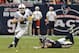 HOUSTON, TX - DECEMBER 16: Andrew Luck #12 of the Indianapolis Colts avoids the tackle by J.J. Watt #99 of the Houston Texans in the second half at Reliant Stadium on December 16, 2012 in Houston, Texas. Texans win 29-17 to clinch the AFC South. (Photo by Bob Levey/Getty Images)