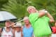 BANGKOK, THAILAND - DECEMBER 06: John Daly of United States plays a shot during round one of the Thailand Golf Championship at Amata Spring Country Club on December 6, 2012 in Bangkok, Thailand. (Photo by Athit Perawongmetha/Getty Images)