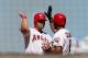 ANAHEIM, CA - SEPTEMBER 23: Kendrys Morales #8 of the Los Angeles Angels of Anaheim celebrates with on deck batter Alberto Callaspo after his two run home run in the sixth inning against the Chicago White Sox at Angel Stadium of Anaheim on September 23, 2012 in Anaheim, California. The Angels won 4-1. (Photo by Stephen Dunn/Getty Images)