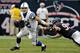 HOUSTON, TX - DECEMBER 16: Andrew Luck #12 of the Indianapolis Colts avoids the tackle by J.J. Watt #99 of the Houston Texans in the second half at Reliant Stadium on December 16, 2012 in Houston, Texas. Texans win 29-17 to clinch the AFC South. (Photo by Bob Levey/Getty Images)