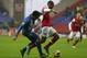 WIGAN, ENGLAND - DECEMBER 22: Jean Beausejour of Wigan Athletic brings down Theo Walcott of Arsenal to concede a penalty during the Barclays Premier League match between Wigan Athletic and Arsenal at the DW Stadium on December 22, 2012 in Wigan, England. (Photo by Clive Brunskill/Getty Images)