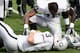Darren McFadden checks on Carson Palmer.