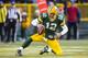 GREEN BAY, WI - DECEMBER 23: Aaron Rodgers #12 of the Green Bay Packers celebrates his touchdown run against the Tennessee Titans at Lambeau Field on December 23, 2012 in Green Bay, Wisconsin. (Photo by Tom Lynn /Getty Images)