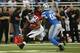 DETROIT, MI - DECEMBER 22: Michael Turner #33 of the Atlanta Falcons runs for a first down as Cliff Avril #92 of the Detroit Lions attempts to make the stop during the fourth quarter of the game at Ford Field on December 22, 2012 in Detroit, Michigan. The Falcons defeated the Lions 31-18. (Photo by Leon Halip/Getty Images)