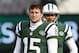 EAST RUTHERFORD, NJ - DECEMBER 23: Quarterbacks Tim Tebow #15 and Mark Sanchez #6, look on as teammate Greg McElroy #14 of the New York Jets passes before the start of their game against the San Diego Chargers at MetLife Stadium on December 23, 2012 in East Rutherford, New Jersey. (Photo by Rich Schultz/Getty Images)