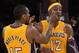 LOS ANGELES, CA - NOVEMBER 16: Metta World Peace #15 of the Los Angeles Lakers helps Dwight Howard #12 with his contact lens during the basketball game against Phoenix Suns at Staples Center on November 16, 2012 in Los Angeles, California. NOTE TO USER: User expressly acknowledges and agrees that, by downloading and or using this photograph, User is consenting to the terms and conditions of the Getty Images License Agreement. (Photo by Kevork Djansezian/Getty Images)