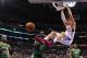 March 12, 2012; Los Angeles, CA, USA; Los Angeles Clippers power forward Blake Griffin (32) hangs on the rim after a dunk as Boston Celtics power forward Kevin Garnett (5) looks on in the second half of the game at the Staples Center. Celtics won 95-84. Mandatory Credit: Jayne Kamin-Oncea-USA TODAY Sports