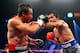 LAS VEGAS, NV - DECEMBER 08: (R-L) Manny Pacquiao throws a left at Juan Manuel Marquez during their welterweight bout at the MGM Grand Garden Arena on December 8, 2012 in Las Vegas, Nevada. (Photo by Al Bello/Getty Images)