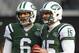 EAST RUTHERFORD, NJ - DECEMBER 23: Quarterbacks Mark Sanchez #6 and Tim Tebow #15 look on as teammate Greg McElroy #14 of the New York Jets passes before the start of their game against the San Diego Chargers at MetLife Stadium on December 23, 2012 in East Rutherford, New Jersey. (Photo by Rich Schultz /Getty Images)