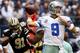 ARLINGTON, TX - DECEMBER 23: Quarterback Tony Romo #9 of the Dallas Cowboys looks for an open receiver under pressure from defensive end Will Smith #91 of the New Orleans Saints at Cowboys Stadium on December 23, 2012 in Arlington, Texas. The New Orleans Saints beat the Dallas Cowboys 34-31 in overtime. (Photo by Tom Pennington/Getty Images)