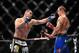 Dec 29, 2012; Las Vegas, NV, USA; Cain Velasquez (left) strikes Junior Dos Santos (right) during UFC 155 at the MGM Grand Garden Arena. Mandatory Credit: Gary A. Vasquez-USA TODAY Sports