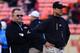 August 30, 2012; San Francisco, CA, USA; San Francisco 49ers offensive coordinator Greg Roman (left) and head coach Jim Harbaugh (right) watch before the game against the San Diego Chargers at Candlestick Park. Mandatory Credit: Kyle Terada-USA TODAY Sports