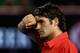 MELBOURNE, AUSTRALIA - JANUARY 26: Roger Federer of Switzerland wipes his face in his semifinal match against Rafael Nadal of Spain during day eleven of the 2012 Australian Open at Melbourne Park on January 26, 2012 in Melbourne, Australia. (Photo by Clive Brunskill/Getty Images)