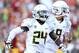 LOS ANGELES, CA - NOVEMBER 03: Running back Kenjon Barner #24 and quarterback Marcus Mariota #8 of the Oregon Ducks celebrate after a 27 yard touchdown run by Barner in the second quarter against the USC Trojans at the Los Angeles Memorial Coliseum on November 3, 2012 in Los Angeles, California. (Photo by Stephen Dunn/Getty Images)