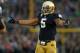 SOUTH BEND, IN - OCTOBER 20: Manti T'eo #5 of the Notre Dame Fighting Irish encourages the crowd to cheer against the BYU Cougars at Notre Dame Stadium on October 20, 2012 in South Bend, Indiana. Notre Dame defeated BYU 17-14. (Photo by Jonathan Daniel/Getty Images)