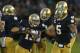 SOUTH BEND, IN - OCTOBER 20: Danny Spond #13 of the Notre Dame Fighting Irish celebrates with teammates including Ishaq Williams #11 and Manti T'eo #5 after intercepting a pass on the next to last play of the game against the BYU Cougars at Notre Dame Stadium on October 20, 2012 in South Bend, Indiana. Notre Dame defeated BYU 17-14. (Photo by Jonathan Daniel/Getty Images)
