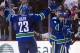 VANCOUVER, CANADA - MARCH 31: Andrew Ebbett #25 of the Vancouver Canucks is congratulated by Sami Salo #6 and Alexander Edler #23 after scoring the game winning goal against the Calgary Flames in overtime to win 3-2 during NHL action on March 31, 2012 at Rogers Arena in Vancouver, British Columbia, Canada. (Photo by Rich Lam/Getty Images)