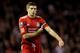 LIVERPOOL, ENGLAND - DECEMBER 26: Steven Gerrard of Liverpool puts on the captain's armband during the Barclays Premier League match between Liverpool and Blackburn Rovers at Anfield on December 26, 2011 in Liverpool, England. (Photo by Scott Heavey/Getty Images)