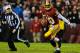 Washington Redskins quarterback RGIII on the move and showing no ill-effects of a sprained knee ligament or a protective knee brace.