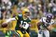 GREEN BAY, WI - DECEMBER 2: Aaron Rodgers #12 of the Green Bay Packers looks to pass the ball while under pressure from Jared Allen #69 of the Minnesota Vikings during the first half of the game at Lambeau Field on December 2, 2012 in Green Bay, Wisconsin. (Photo by Joe Robbins/Getty Images)