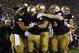Oct 13, 2012; South Bend, IN, USA; Notre Dame Fighting Irish wide receiver T.J. Jones (7) is congratulated by teammates after scoring the winning touchdown against the Stanford Cardinal at Notre Dame Stadium. Notre Dame defeats Stanford in overtime 20-13. Mandatory Credit: Brian Spurlock-USA TODAY Sports