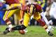 LANDOVER, MD - JANUARY 06: Robert Griffin III #10 of the Washington Redskins is injured as he fumbles a bad snap in the fourth quarter against the Seattle Seahawks during the NFC Wild Card Playoff Game at FedExField on January 6, 2013 in Landover, Maryland. (Photo by Al Bello/Getty Images)