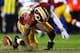 LANDOVER, MD - JANUARY 06: Robert Griffin III #10 of the Washington Redskins is injured as he fumbles a low snap in the fourth quarter against the Seattle Seahawks during the NFC Wild Card Playoff Game at FedExField on January 6, 2013 in Landover, Maryland. (Photo by Al Bello/Getty Images)